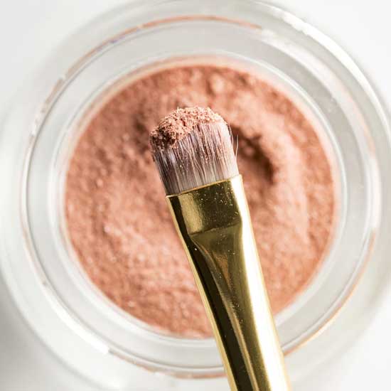 Paintbrush dipped in apricot color